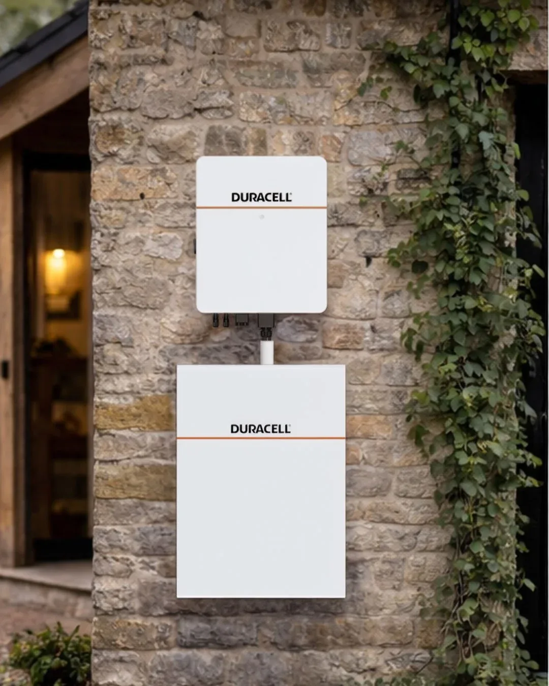 Two Duracell Energy units on a stone wall beside climbing ivy